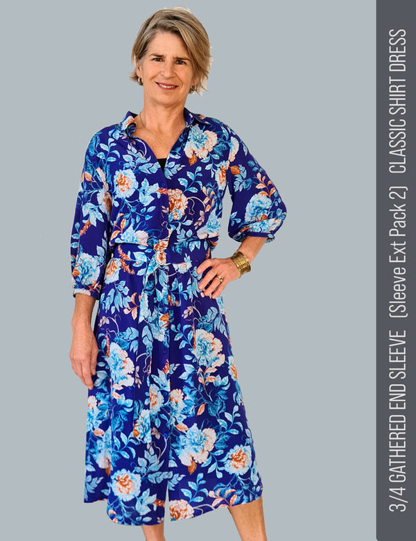 Woman wearing a designer blue floral dress sewn from vibrant floral printed silk