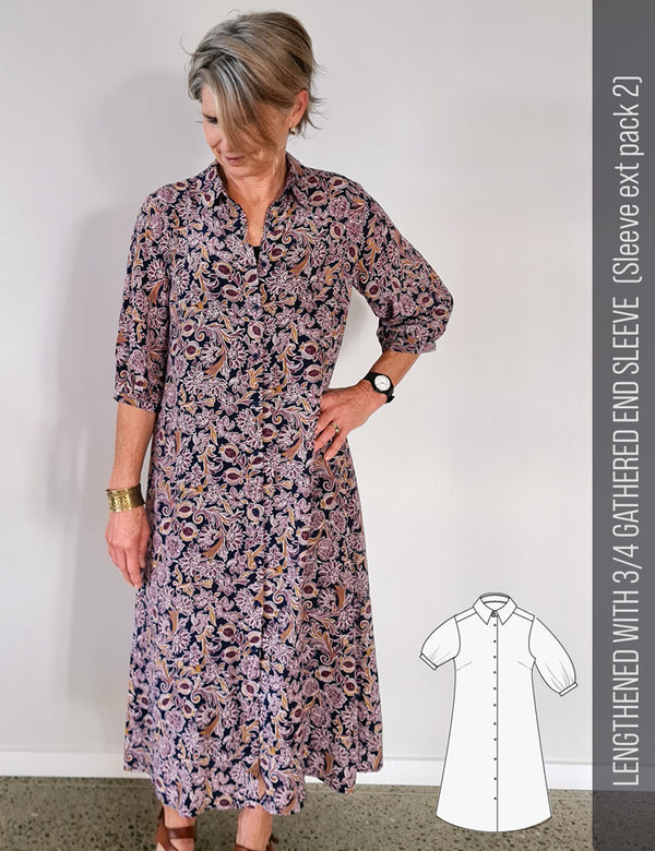 Woman wearing a patterned silk shirt dress with a sewing pattern illustration on the side.
