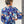 Load image into Gallery viewer, Back view of woman wearing a designer blue floral dress sewn from vibrant floral printed silk
