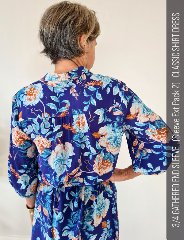 Back view of woman wearing a designer blue floral dress sewn from vibrant floral printed silk